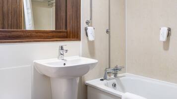 A bathroom with a toilet, sink, and bathtub.