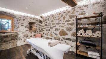 Relax in a serene space with a massage table, towels, and amenities at your fingertips.