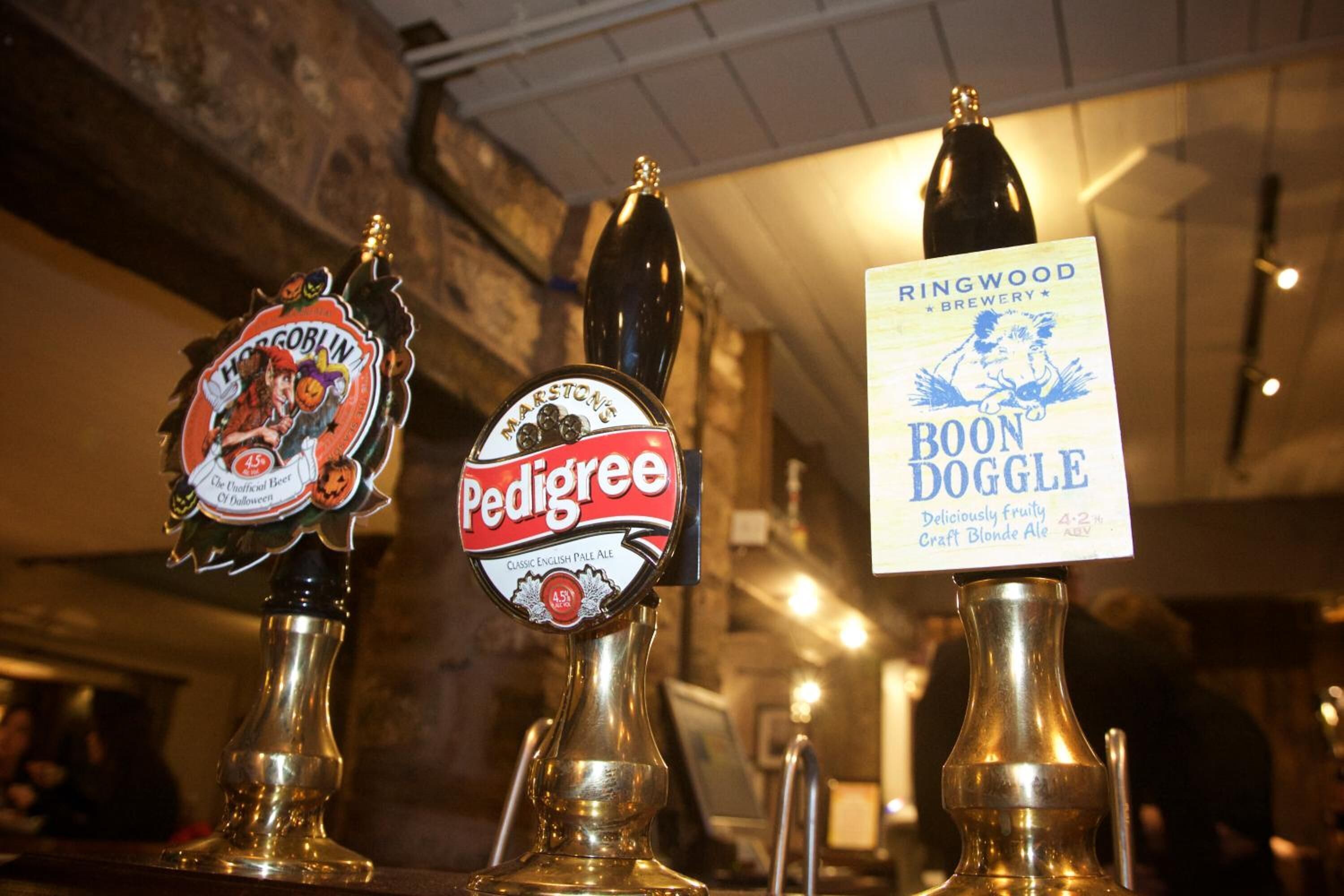 Three beer taps labeled Pedigree, Hog Goblin, and Boon Doggle.