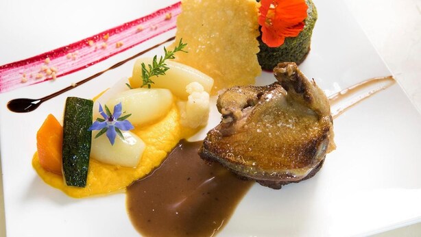 A plated dish with various food items including a piece of meat, vegetables, and a sauce. - Hotel Le Relais de Farrou (Saint-Remy)