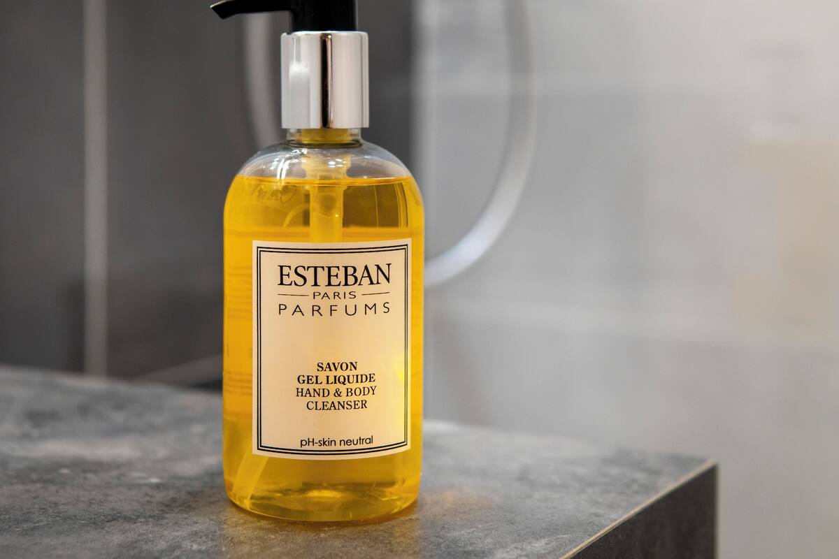 A bottle of Esteban Paris Parfums Savon Gel Liqueur Hand & Body Cleanser on a countertop.