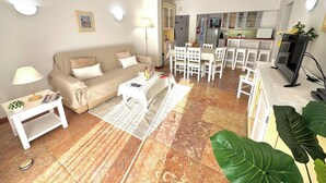 Una sala de estar con sofá, mesa de centro y comedor con sillas y una mesa.