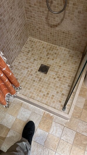 Bathtub, hair dryer, towels, toilet paper