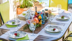 A table set for a meal with plates, glasses, and a variety of beverages.