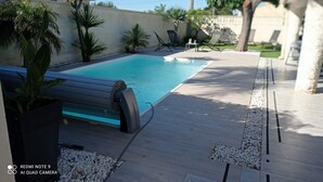 A swimming pool with a tiled deck, surrounded by lounge chairs and potted plants. - “Ampolla Villa”, 5 min away from the beach, 500 sqm garden, 9 persons (L' AMPOLLA)