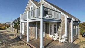 A two-story house with a covered porch and a deck. - OCEAN VIEWS! Immaculate Quintessential Nantucket Beach Cottage see virtual tour. (Nantucket)