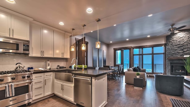 A modern kitchen with stainless steel appliances, a central island, and pendant lighting. - Great Location, Chef (Park City)