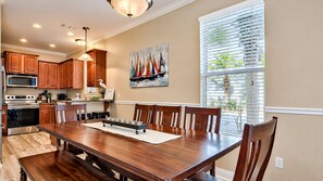 Spacious dining area featuring a large 8–9-seater coastal table, with a kitchen bar for two. - 🏝️ Seaside Therapy| 6BR | Near Resort Pool and Beach! (Destin)