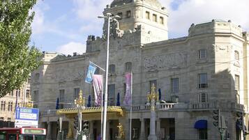 A historic building with classical architecture, featuring a prominent dome and columns.