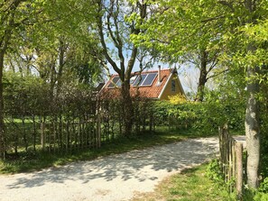 Escape to a serene rural haven surrounded by lush greenery and a wooden fence.