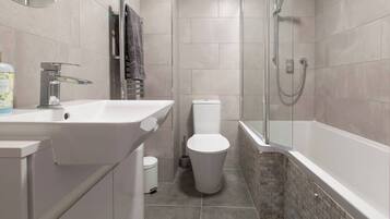Combined shower/bathtub, hair dryer, towels, toilet paper