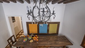 A dining table with a chandelier, chairs, and a fruit bowl. - VILLA FRARI IN CAMPIELLO (Venezia)