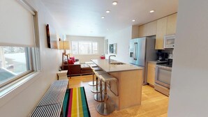 A modern kitchen with a central island, stainless steel appliances, and a bright, open layout. - Villas at Snowmass Club - 1210 ~ Snowmass Club Access ~ (Snowmass Village)