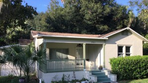 A single-story house with a porch, a small front yard, and a mailbox. - Orange Blossom in Historic McIntosh (McIntosh)
