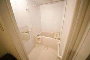 A small, white bathroom with a shower, a toilet, and a sink. - Best Residence Kujo 502 (Osaka)