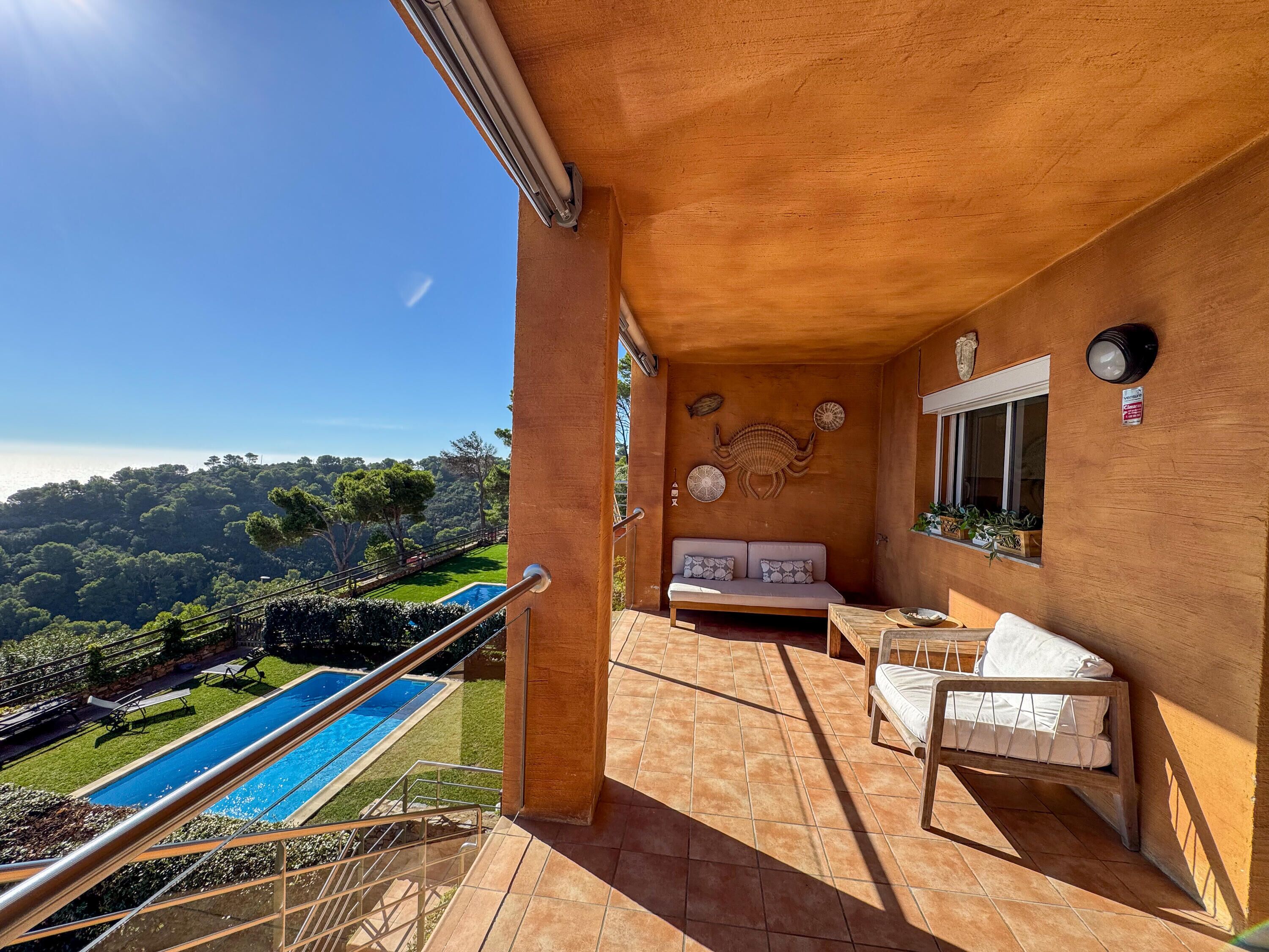 A balcony with a pool, a sofa, and a bed.