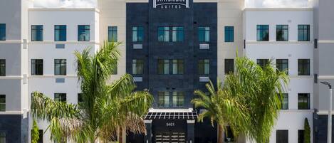 Un bâtiment de l’hôtel Staybridge Suites, doté d’une façade moderne, de grandes fenêtres et d’une entrée centrale.