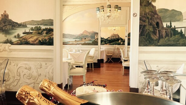 A dining area with a large table, chairs, and a chandelier. There is a large painting on the wall depicting a landscape. - LUXa Charmhouse Hotel (Sintra)