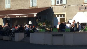 A hotel restaurant with outdoor seating, a sign indicating 'Hotel Restaurant', and a visible entrance. - Rod & Sève (Propières)