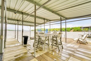 Enjoy dining or socializing on the deck overlooking the water and lush surroundings.
