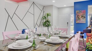 A dining area with a glass table set for four, surrounded by pink chairs. - Near Las Vegas Strip and Airport: Games & Arcades- Southpoint less than 5 mins. (Las Vegas)