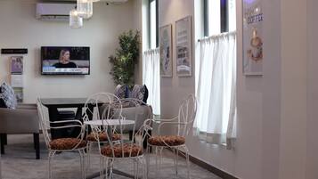 A modern interior with a dining area, a television, and decorative elements.