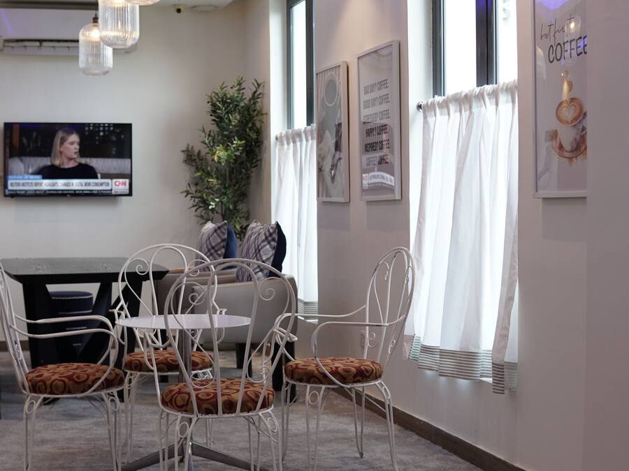 A modern interior with a dining area, a television, and decorative elements.