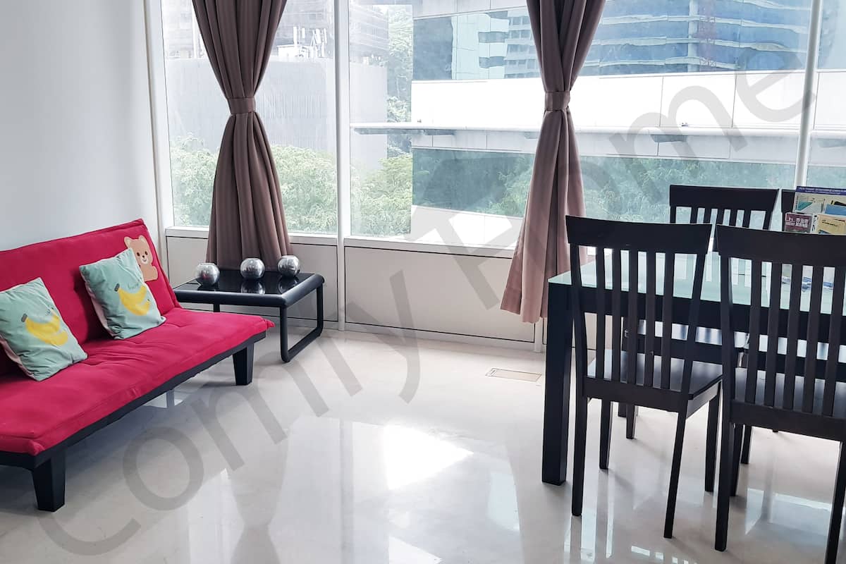 A modern living room with a red sofa, two black chairs, a small table, and a large window with curtains.