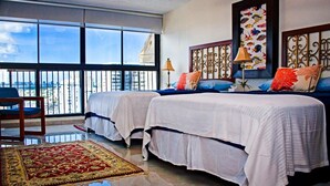 A hotel room with two beds, a large window with a city view, a decorative wall, and a red patterned rug. - tlLuxury Penthouse Oasis, Steps to the Beach, Spacious, Pool & Near Dining (Carolina)