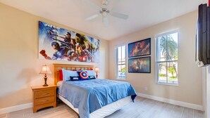 A bedroom with a bed, nightstands, a ceiling fan, and artwork on the walls. - 4BR Regal Palms Townhome by FS FL VH-154 (Davenport)