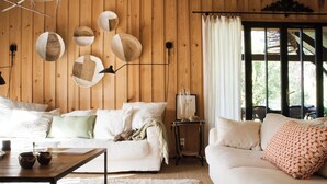 En hyggelig stue med en hvid sofa, et træbord og en lampe.