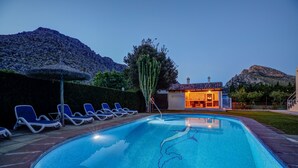 A swimming pool with lounge chairs, a cactus, and a building with a tiled roof. - Villa Can Lluc(Private villa with big barbecue) (Puerto de Pollença)