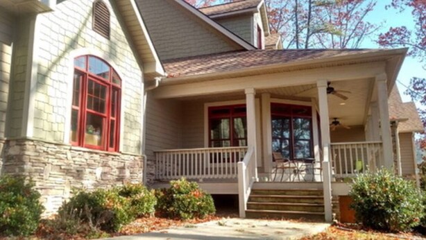 A two-story house with a stone facade, a front porch with a white railing, and a red-framed window. - Location!! Pis Nat F., DuPont, Brev. & Ash. 5 bedrooms, 3.5 baths, Sleeps 16! (pisgah forest)