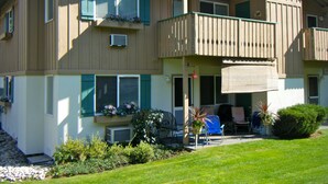 A two-story building with a balcony, outdoor seating, and a small garden area. - Welcome to the Bean's Pod :-) (Leavenworth)