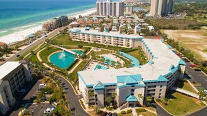 A resort with a large pool, multiple buildings, and a beach view. - Aug/Sept Openings SAVE Large Walk Off  Patio w/Grill. 2 Pools, Beach Service!!!! (Miramar Beach)