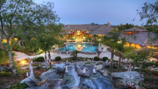A large house with a swimming pool, a waterfall, and well-maintained gardens. - Paradise Vacation Estate - Largest Luxury Private Vacation Resort (Temecula)