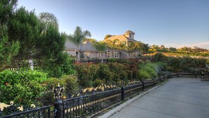 A landscaped garden with a building featuring a dome and a tower. - Paradise Vacation Estate - Largest Luxury Private Vacation Resort (Temecula)