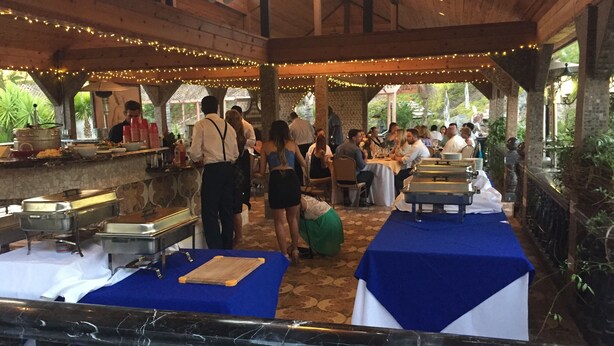 A covered outdoor dining area with tables and chairs, string lights, and a buffet setup. - Paradise Vacation Estate - Largest Luxury Private Vacation Resort (Temecula)