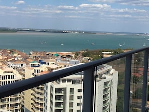 A coastal cityscape with high-rise buildings, a marina with boats, and a clear sky. - Darwin City Harbour Views-above the Oak Restaurant (Darwin City)