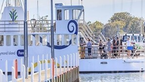 A ferry with a logo and text indicating it is a service to Raymond Island.