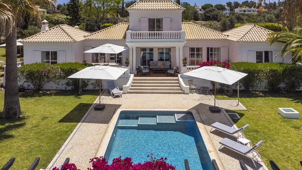 A two-story house with a swimming pool, outdoor furniture, and a garden. - Villa Atlantico (Carvoeiro)