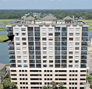 A multi-story hotel with a uniform facade, large windows, and balconies.