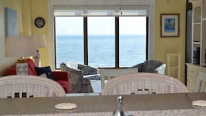 A room with a view of the sea, wicker furniture, a white cabinet, and a lamp. - Beautiful Ocean and Inlet Views From This Newly Updated Corner Unit (North Myrtle Beach)