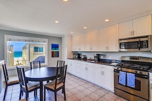 Enjoy meals at the dining table with a view of the beach.