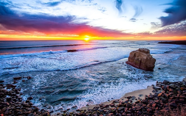 Experience the serene beauty of the coastline with its rugged shoreline and crashing waves.