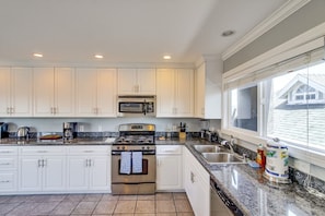 Enjoy cooking in this well-equipped kitchen with a stove, oven, and microwave.