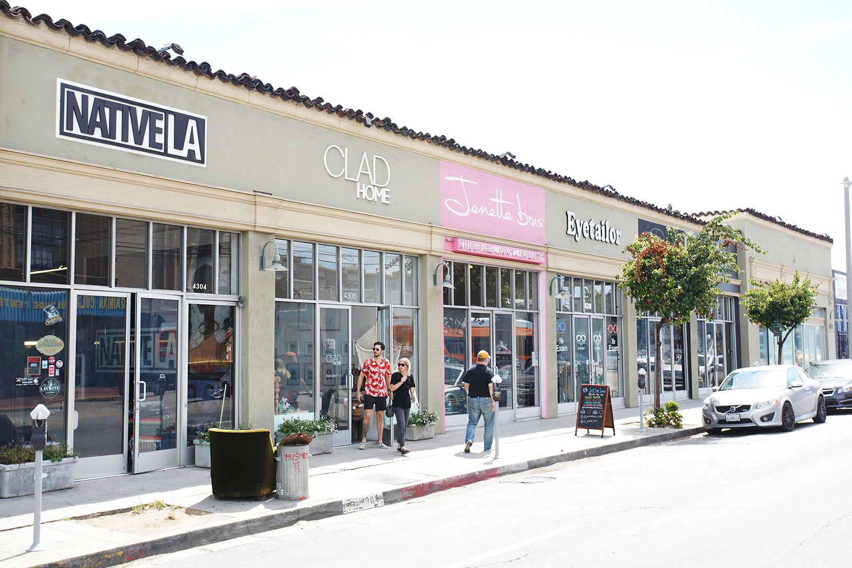 Une devanture de magasin avec les enseignes « NATIVE LA », « CLAD HOME », « Jenette » et « Eyetailor ».