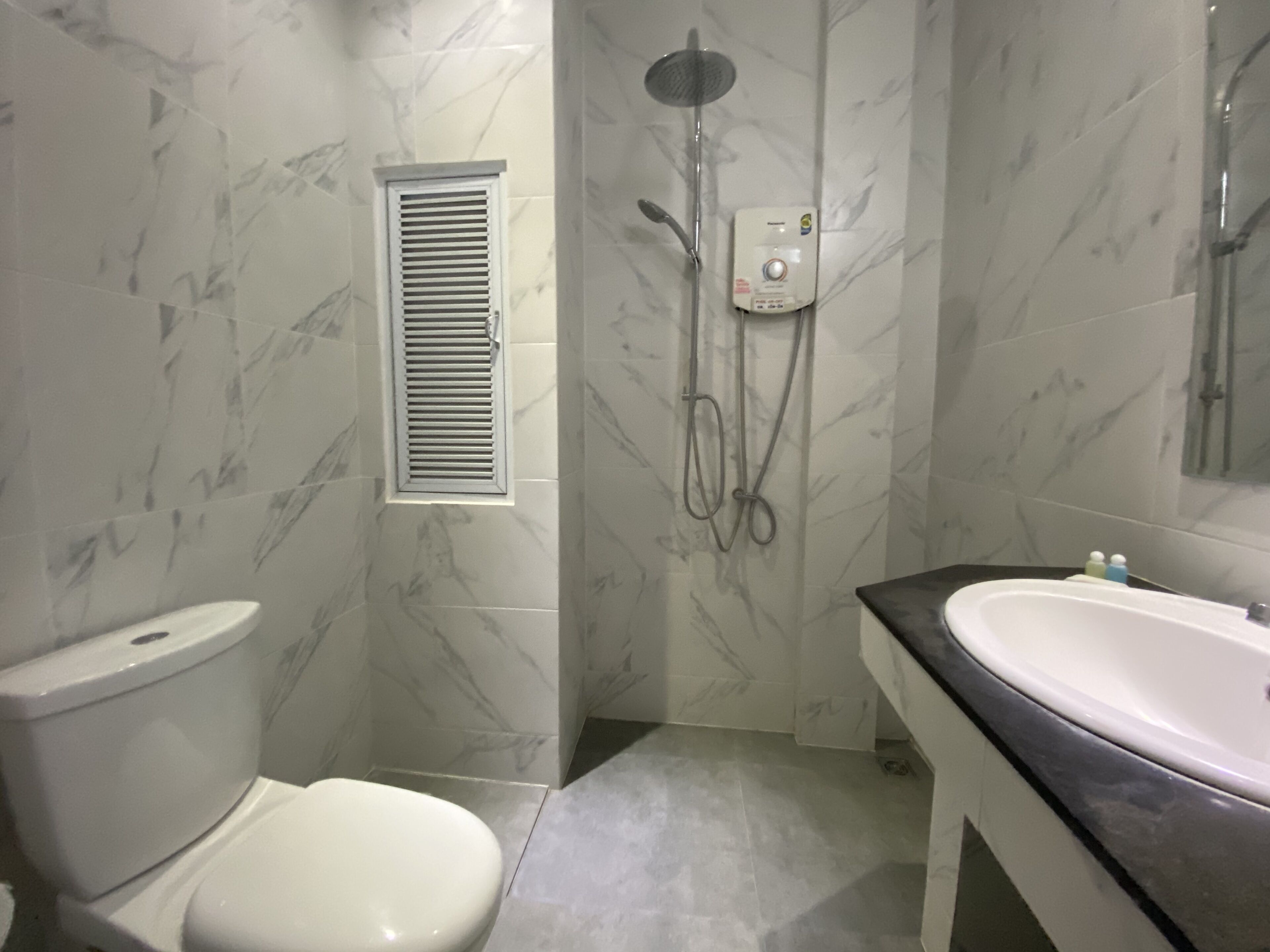 junior studio, 1 queen bed | bathroom | shower, free toiletries, hair dryer, towels