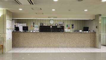 A reception area with a counter, a clock, and a sign labeled "RECEPTION".