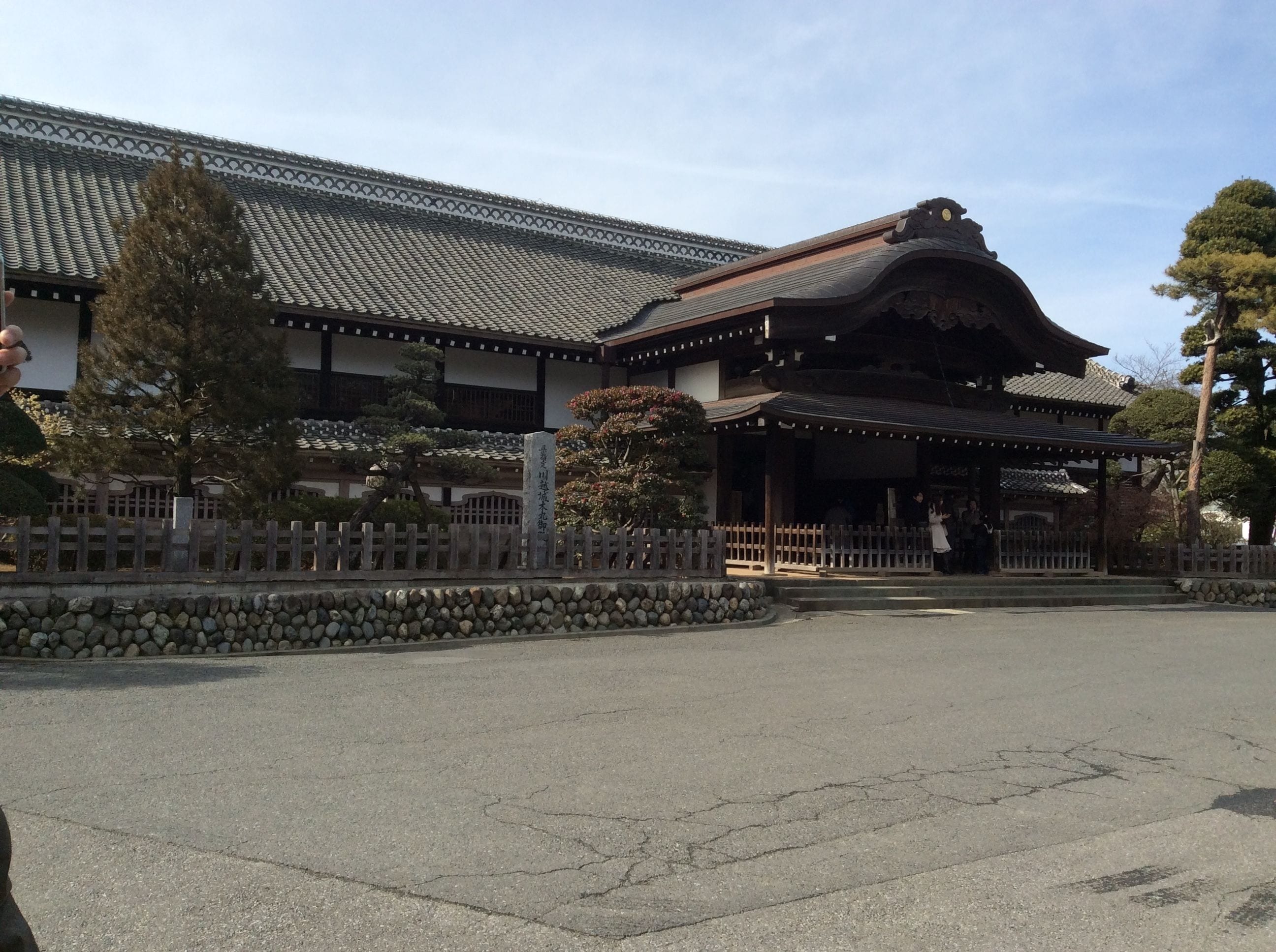 A traditional Japanese building with a tiled roof and wooden structure.